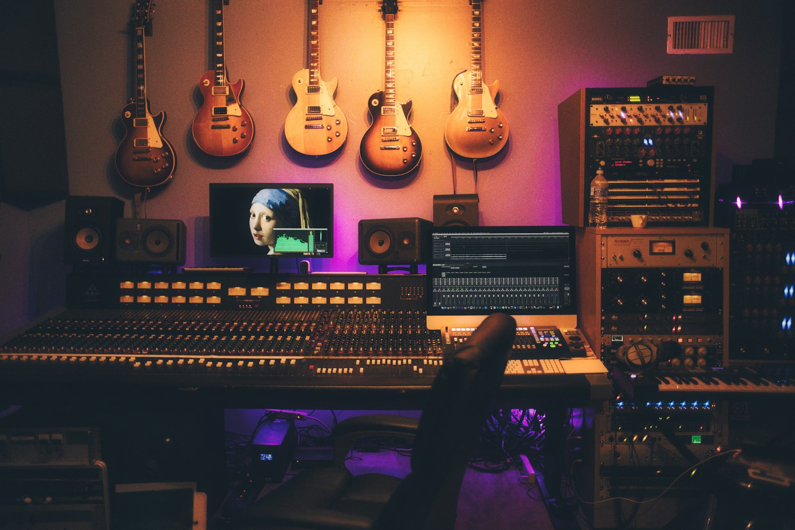 Music production setup with mixing console and studio monitors