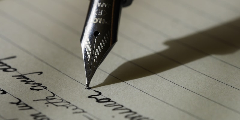 Close-up of hands typing on a laptop keyboard with a document editor open showing text being revised